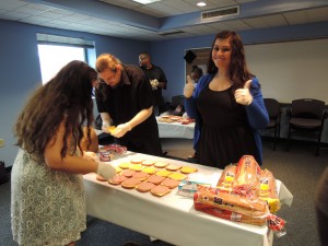 Alli Lake (with thumbs up) participates in CYC's community service making sandwiches for the Drop Inn Center